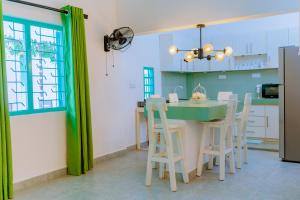 a kitchen with a table and chairs and a window at Istana Villa Mirissa in Mirissa