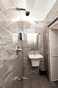 a bathroom with a sink and a shower at Istana Villa Mirissa in Mirissa
