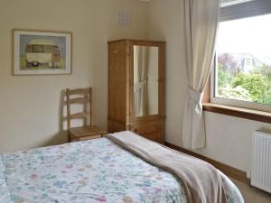 a bedroom with a bed and a window at Anchorage in Maidens