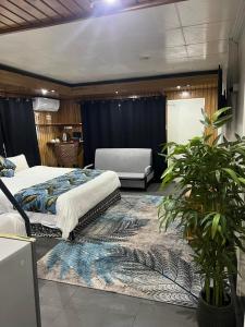 a bedroom with two beds and a table and a couch at Matasawa Resort - Wailoaloa, Nadi in Nadi