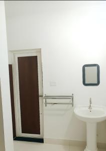 a bathroom with a sink and a mirror at ISKCON Mayapur Apartments - Daily & Monthly Rentals- PRIME LOCATION - SERVICED Apartment, 5 MIN to MAIN ISKCON TEMPLE in mayapur