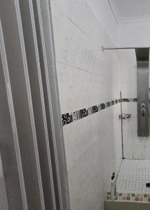 ein Bad mit Dusche, WC und Fliesenboden in der Unterkunft Shado's residence self catering cotages in Serowe