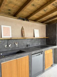 a kitchen with a sink and a stove at Bibi in La Trinité +18 photos