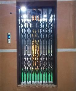 a door with a iron gate on a wall at ISKCON Mayapur Apartments - Daily & Monthly Rentals- PRIME LOCATION - SERVICED Apartment, 5 MIN to MAIN ISKCON TEMPLE in mayapur