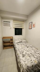 Giường trong phòng chung tại ZX Homes Banilad +4 ảnh