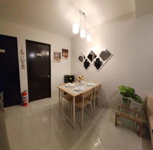 a dining room with a table and chairs in a room at 2 Bedroom Condo UDH by ZX Homes Banilad in Mandaue City +4 photos