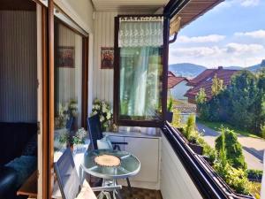 a balcony with a table and a large window at Apartment in Herrischried in Herrischried