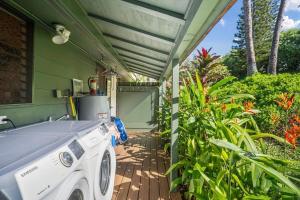 a house with a washing machine on a porch at International Colony Club 37 · ICC 37 Remodeled Hawaiian Cottage in Kaanapali