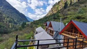 a view from a balcony of a resort in a mountain at Parvati valley cottages & cafe in Tosh