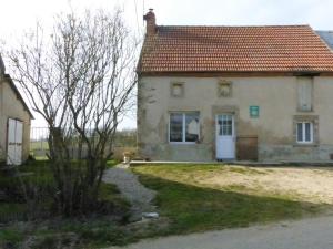 a house with a red roof and a dog in front of it at Gîte indépendant à Saint-Genest avec jardin clos - FR-1-489-562 in Saint-Genest +4 photos