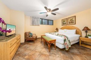 a bedroom with a bed and a ceiling fan at Papakea K103 · PK K103 Ocean views Condo | Lanai + AC + Pool in Kaanapali +52 photos