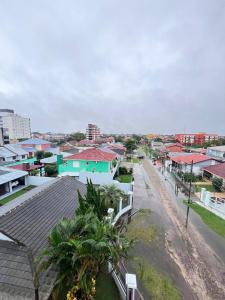 arial view of a city with houses and palm trees at Residencial Palazzo in Tramandaí