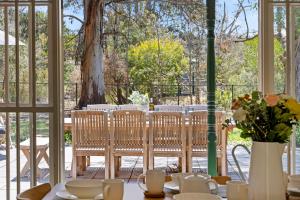 a room with a table and chairs and a window at Raygold Park Equestrian Accommodation plus Pool House in Moorooduc