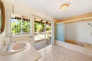 a bathroom with a sink and a large mirror at Hale Kalapu · Large Home 180° Ocean Views Walk2Beach Hale Kalapu in Kaanapali +77 photos