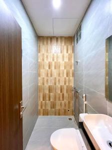 a bathroom with a toilet and a sink at Aura Beachfront Hotel - Apartment in Da Nang