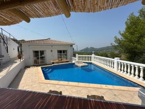 una piscina en un patio trasero con una valla blanca en Beautiful villa with pool and stunning view, en Boterías