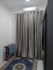 a shower curtain in a room with a rug at Inara Homestay in Kuala Lipis +7 photos