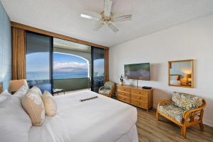 a bedroom with a large bed and a large window at Lahaina Shores PH1 · LS PH1 Oceanfront Penthouse Condo w Panoram in Lahaina +42 photos