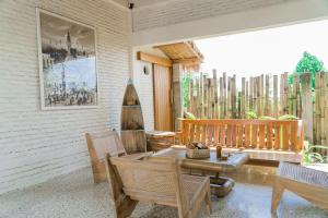 a patio with a table and chairs on a porch at Mantra Yoga Homestay in Tanjung