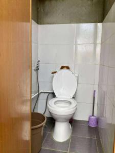 a bathroom with a white toilet in a room at San Juan ELYU Beachfront Cabin in San Juan +8 photos