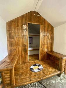 a large wooden room with a bed in it at San Juan ELYU Beachfront Cabin in San Juan