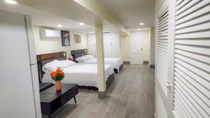 a bedroom with two beds and a table with flowers at Amazing private single family house in Glendale