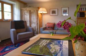 a living room with a couch and a table at Alpine Chalet Apartment With Zugspitze Views in Grainau