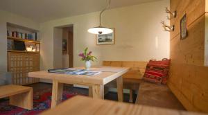 a living room with a table and a couch at Alpine Chalet Apartment With Zugspitze Views in Grainau +4 photos