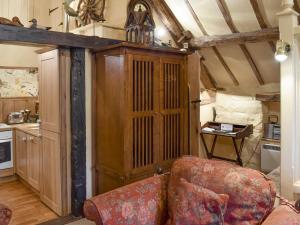 a living room with a couch and a cabinet at The Hayloft - Igp in Glaisdale