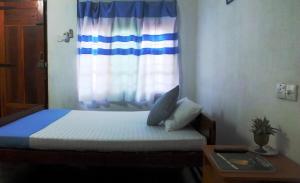 Postel nebo postele na pokoji v ubytování D'Villa Guest House