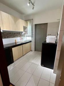 a kitchen with a counter and a microwave in it at Mi Haven Homestay Seribong KB City in Kota Bharu
