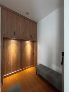a living room with wooden cabinets and a couch at Mi Haven Homestay Seribong KB City in Kota Bharu