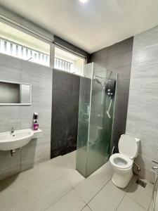a bathroom with a shower and a toilet and a sink at Mi Haven Homestay Seribong KB City in Kota Bharu +5 photos
