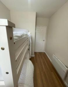 a small room with a bed and a closet at Flat 9 Haden in Wolverhampton