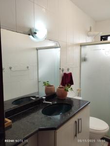a bathroom with a sink and a mirror at Refúgio aconchegante in Salvador