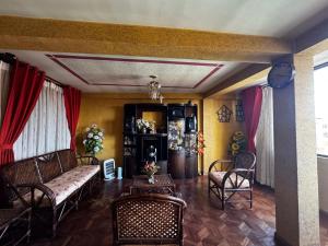 a living room with a couch and chairs and a table at Altura View Stay in La Paz