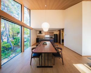 a large dining room with a large wooden table at Kamuy Chalet Hakuba by Jade Villa in Hakuba