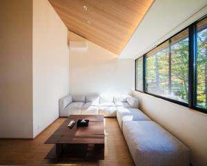 a living room with a couch and a table at Kamuy Chalet Hakuba by Jade Villa in Hakuba