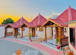 a row of houses with red roof at Holiday Homestay dholavira 