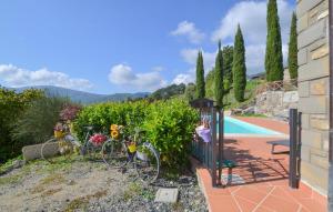 a house with a bike parked next to a pool at Amazing Apartment In Caprese Michelangelo in Caprese Michelangelo