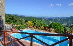 a pool on the balcony of a house at Amazing Apartment In Caprese Michelangelo in Caprese Michelangelo