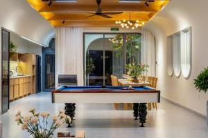 a pool table in the middle of a room at BQ Manor by Class6 in Danang