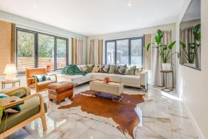 a living room with a couch and a table at Palm Beach House in Mudeford