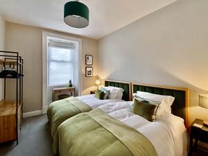 a bedroom with two beds and a window at 2 Harney Peak in Portinscale +2 photos