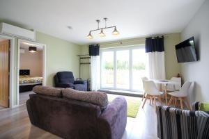 a living room with a couch and a table at Gwel An Koos in Bodmin