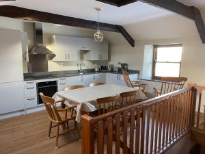 a kitchen and dining room with a table and chairs at 5 Swallowholm Cottages in Richmond +18 photos