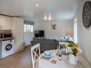 a living room with a couch and a table at The Shambles in Fulletby