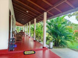a porch of a house with a table and chairs at Wilpattu Gagana guest in Nochchiyagama