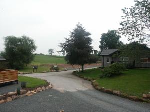 a winding road with a house and a bench at Amber Nook in Tirril