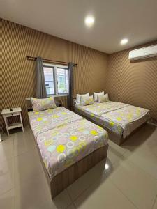 two beds sitting in a room with at Baan Dara Resort in Sara Buri +53 photos